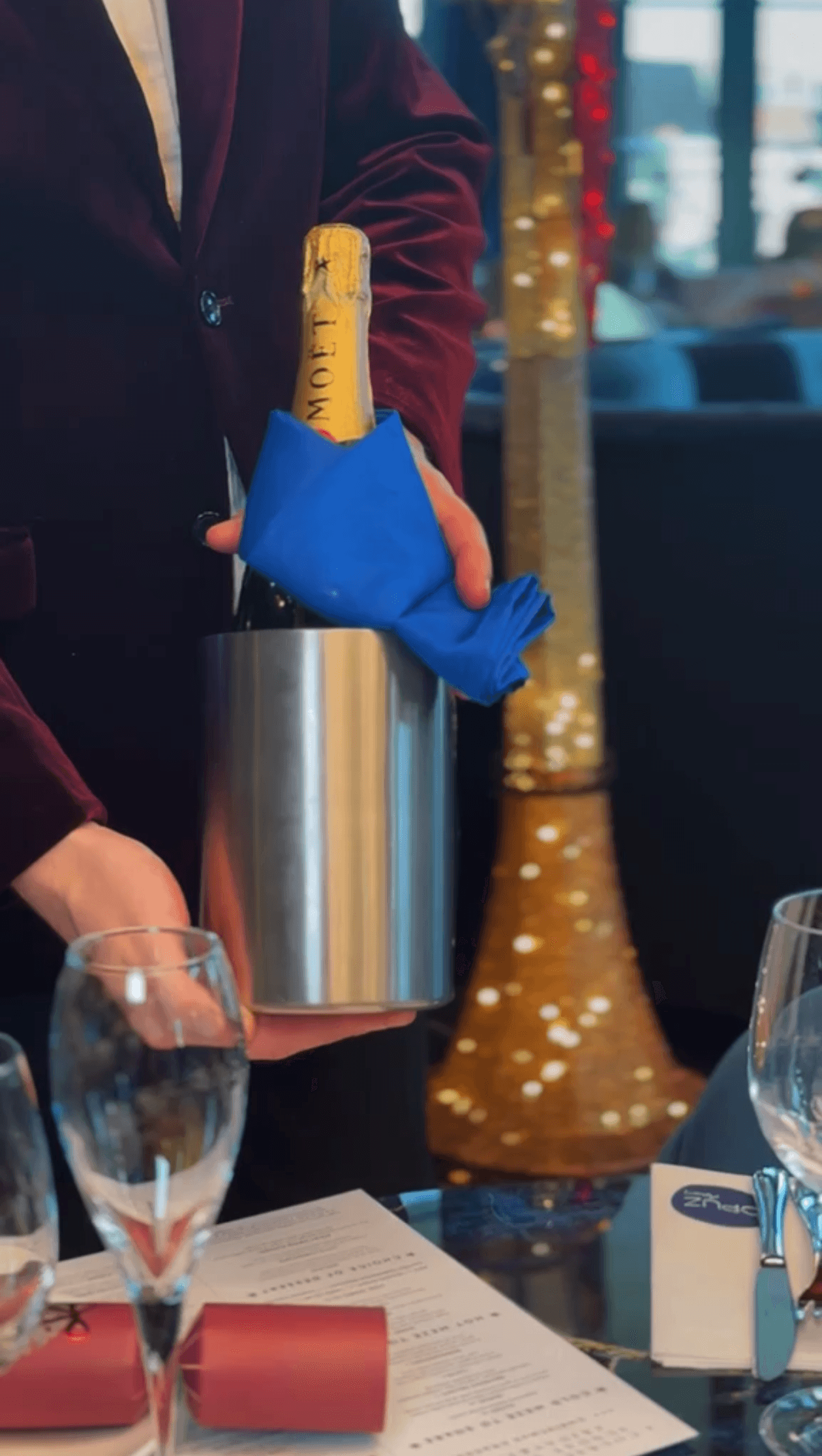 Guests raising a toast with wine glasses over dinner
